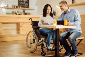 disabled woman working with husband on application