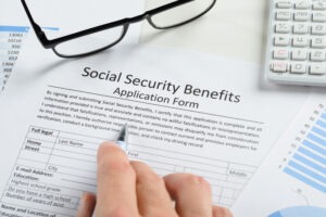 glasses and pen on social security benefits application form