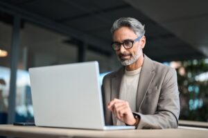 A man researching on his computer how many work credits he needs to qualify for disability at age 55