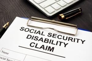 A clipboard holds a Social Security Disability claim form. Pilzer Klein can educate you on what not to say at a Social Security Disability hearing in 2026.